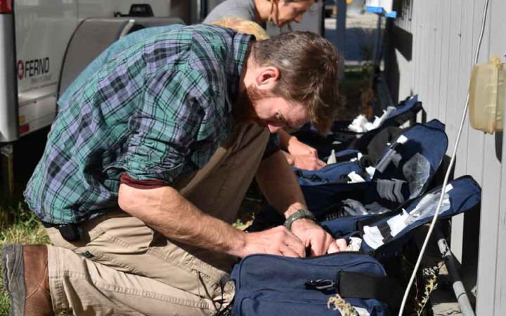 Outward bound students appear to pack medical bags during a service project